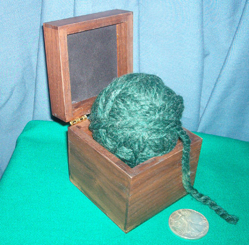 coin in ball of wool